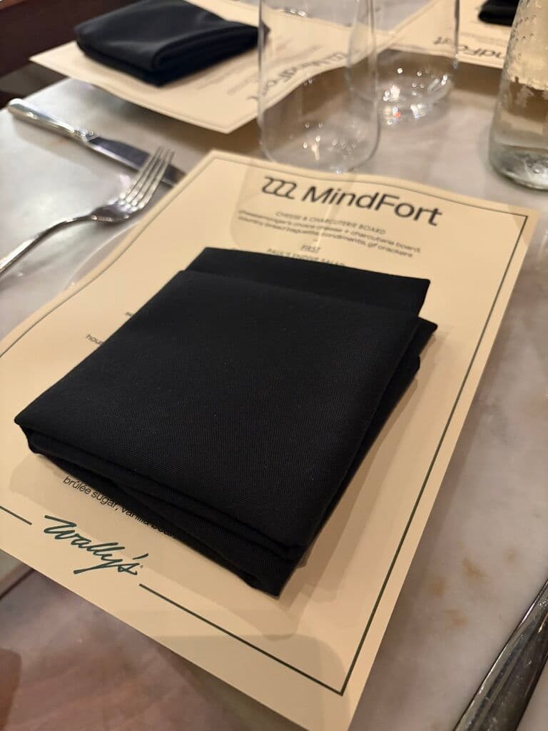 A MindFort dinner menu beneath a folded black napkin